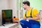 The male professional serviceman repairing tv at home