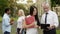 Male professor discussing thesis with asian female student near university