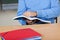 Male Professor Holding Book While Sitting At Desk