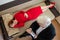 A male psychotherapist writes on a clipboard during a patient consultation. Top view of an emotional woman lying on a