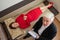 A male psychotherapist writes on a clipboard during a patient consultation. Top view of an emotional woman lying on a