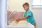 Male Pupil At Montessori School Washing Hands In Washroom