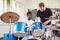 Male Pupil With Teacher Playing Drums In Music Lesson