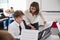 Male Pupil With Teacher Playing Piano In Music Lesson