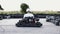 Male racer in protective helmet racing on the go-kart track outdoors