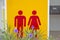 Male red-female toilet symbol, yellow background with purple flo