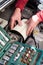 Male repairman hands inserting air filter cartridge in plastic box of car engine, tools kit is on a foreground