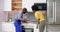 Male Repairman Installing Induction Cooker With Woman Standing