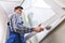 Male Repairman Installing Window