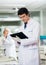 Male Researcher Reading Clipboard