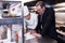 Male restaurant manager writing on clipboard while interacting to head chef