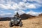 Male rider sitting on ATV at mountain