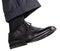 Male right foot in black shoe takes step