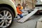 Male road worker preparing car for evacuation