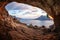 Male rock climber climbing along a roof in a cave