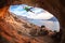 Male rock climber climbing along a roof in a cave