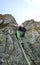 Male rock climber on a steep granite climbing route in the Swiss Alps near St. Moritz