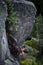 Male rock climber struggles to climb a challenging overhanging. Extreme sport climbing.