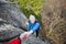 Male rockclimber is helping a climber female