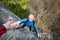 Male rockclimber is helping a climber female