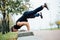 Male runner doing exercise, workout in the fall park. Push ups with bench.