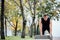 Male runner doing exercise, workout in the fall park. Push ups with bench.