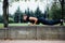 Male runner doing exercise, workout in the fall park. Push ups with bench.