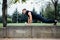 Male runner doing exercise, workout in the fall park. Push ups with bench.