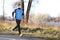 Male runner man running in autumn on cold day