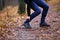 Male runner touching cramped calf at jogging