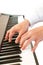 Male\'s hand playing piano.