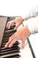 Male\'s hand playing piano.