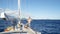 Male sailor on a yacht sail boat on the open ocean near Antigua in the Caribbean island nation Antigua and Barbuda.