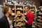 Male salesperson showing cheese to female customer in store