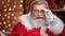 Male Santa Claus laughing putting on glasses seeing wonder. Medium close up shot on 4k RED camera