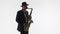 Male saxophonist in a suit and hat plays a gold saxophone. Skill of playing the saxophone. mockup for double exposure