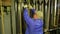 Male scene worker puts the load on the lifting mechanism of the theater curtain