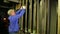 Male scene worker puts the load on the lifting mechanism of the theater curtain