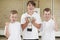 Male School Sports Team In Gym With Trophy