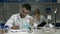 Male scientist examining flask with liquid in lab