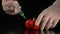 Male scientist hands with syringe injecting red pepper