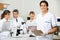 Male Scientist Holding Clipboard In Lab