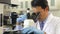 Male Scientist Using Microscope In Laboratory