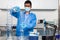 Male scientist working at laboratory dressed in blue