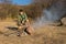 Male Scout Grilling Sausages in Old Way