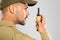 Male security guard in  using portable radio transmitter on grey background, closeup