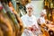 Male seller offering sliced bacon in butcher shop