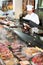 Male seller posing with wursts in butchery