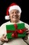 Male Senior With Santa Claus Cap and Green Gift