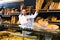 Male shop assistant demonstrating delicious loaves of bread in bakery